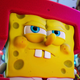 SpongeBob stares determinedly as he stands in the middle of a cityscape.